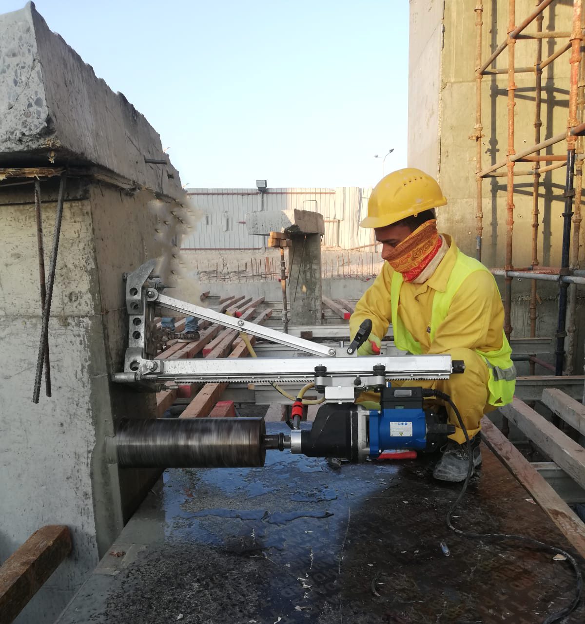 Diamond core drilling rig set up on a reinforced concrete slab on a Doha construction site