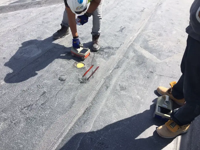 A site engineer interpreting Ground Penetrating Radar data on a concrete slab in Doha